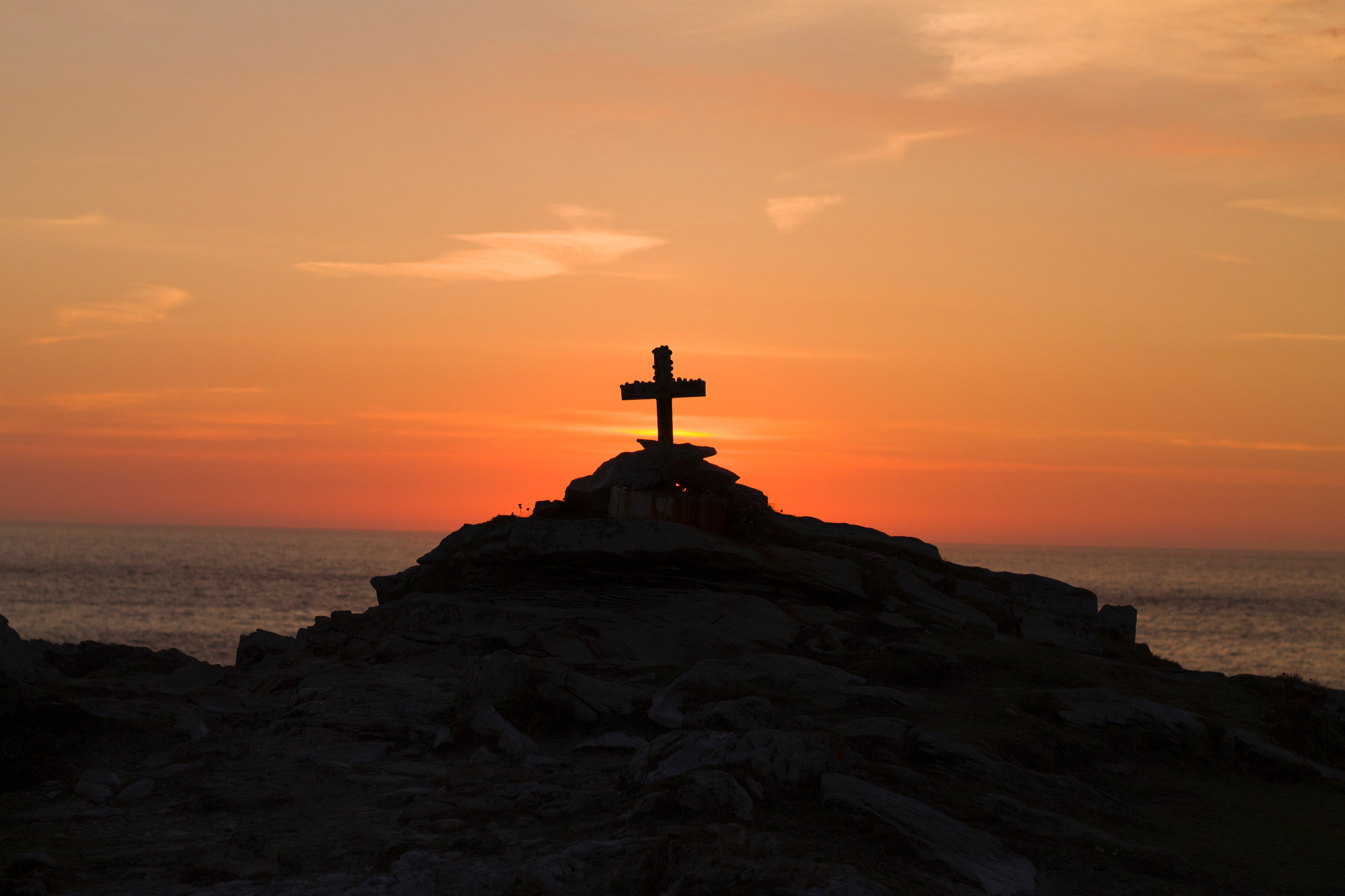 silhouette of christian cross against a beautiful sunset