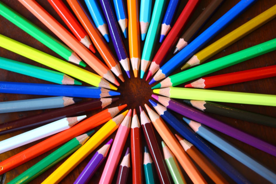 different coloured pencils laid flat to form a circle